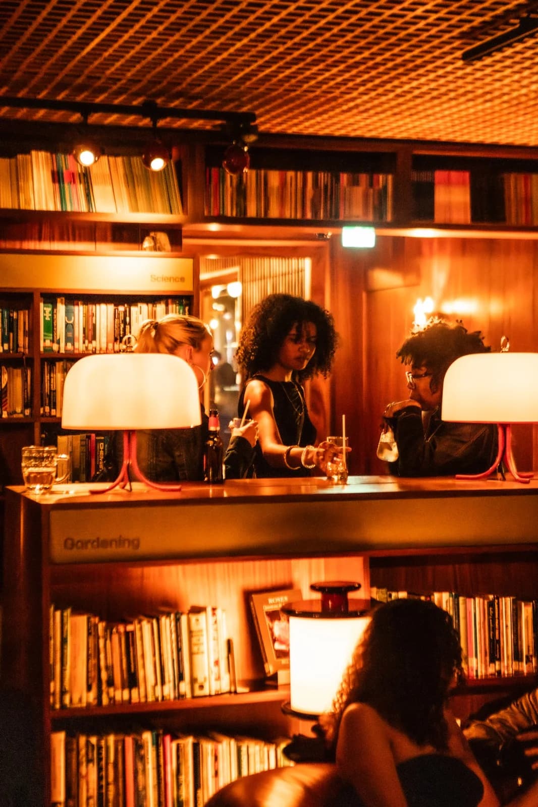 Guests gathered around the bar in The Standard's book-lined Library Lounge